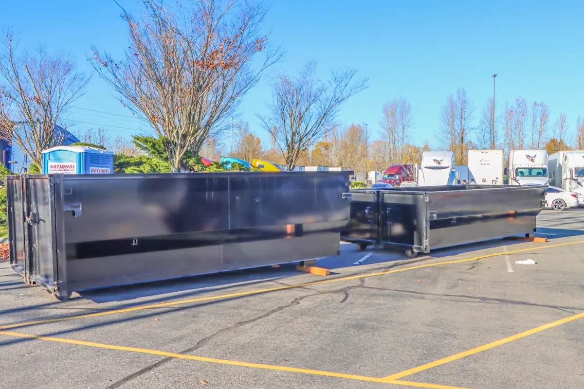 Professional dumpster rental service with roll-off container on residential driveway in Manhattan Beach